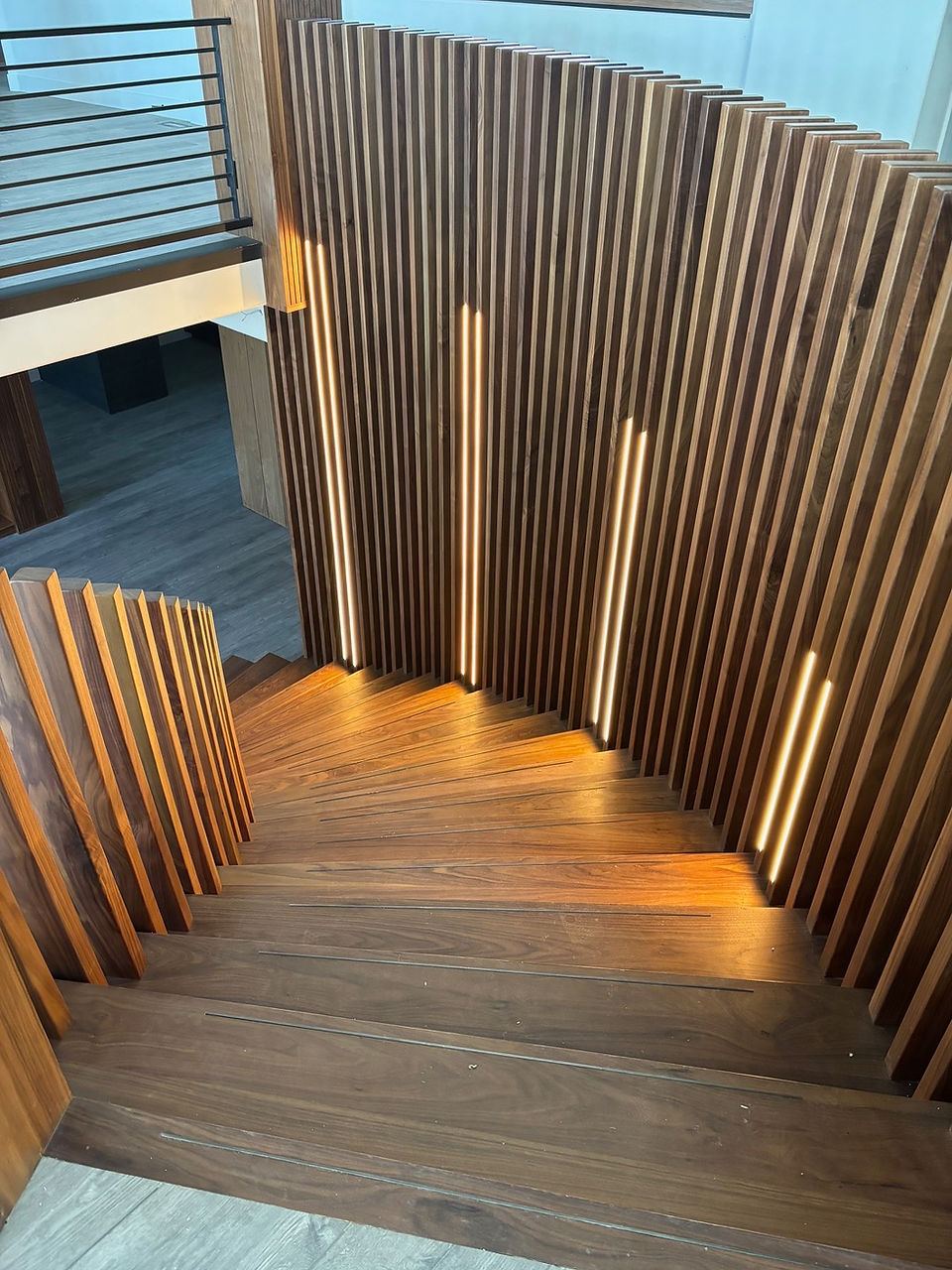 Architectural spiral staircase in walnut, integrating form and function in the Preserve Lane renovation