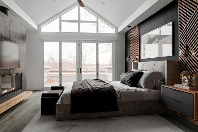Bedroom with vaulted ceiling, floor-to-ceiling windows, and minimalist fireplace