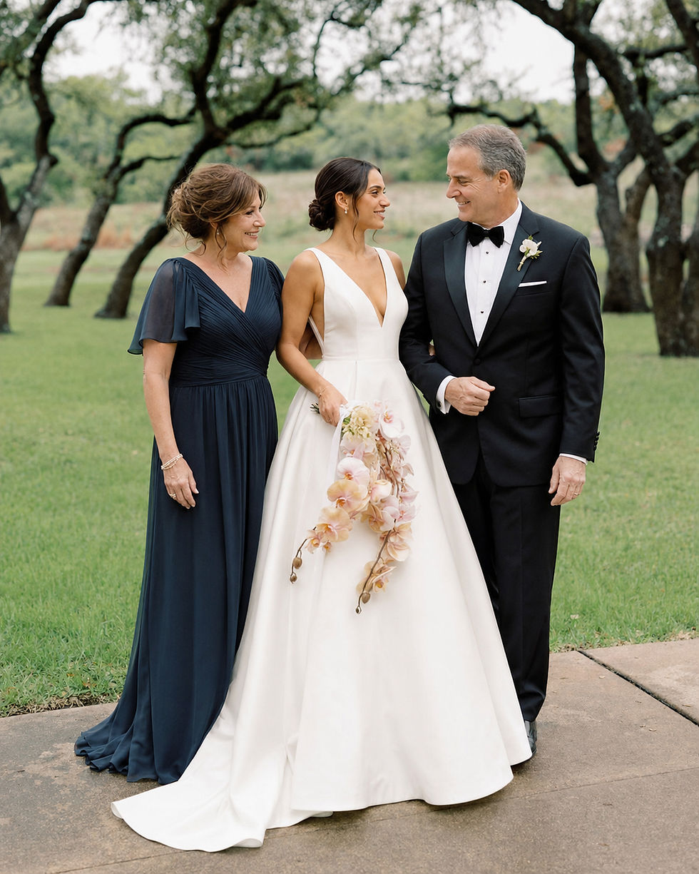 Bride wearing a custom deep-V satin A-line wedding dress with wide straps and a full skirt, walking outdoors with her parents by Studio RÉN.