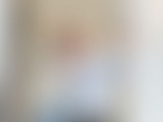 couple holding up keys in front of their new house