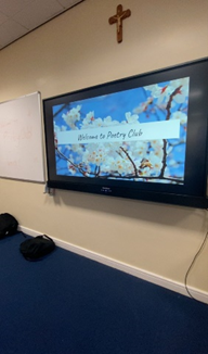 An interative board with a presentation displayed that reads 'Welcome to Poetry Club.'