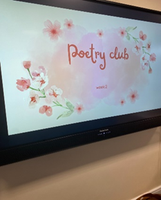 Screen that has a presentation on it that is titled 'Poetry Club'