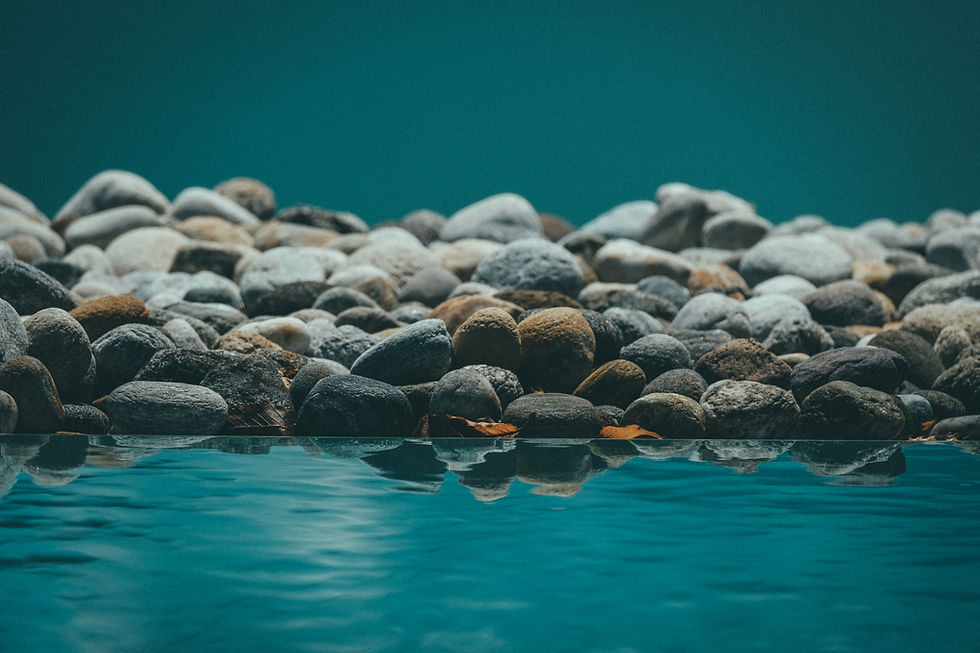 beautiful-shot-resting-water-reflecting-rocks.jpg