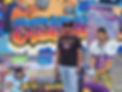 The CEO of Black Maverick Comics, standing by his booth at a school event. He is wearing his iconic D-Voyant Eye t-shirt.