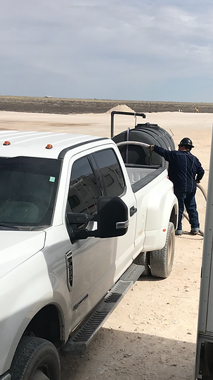 Man putting hose in truck