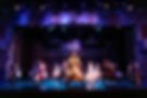 The cast sings a song in Spamalot.
