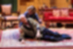 Liz comforts Garry on the floor of his flat.