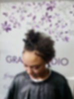 Client with short natural curly hair before a Partial Sew-In hair extension installation using the Raw Indian Human Hair Collection.