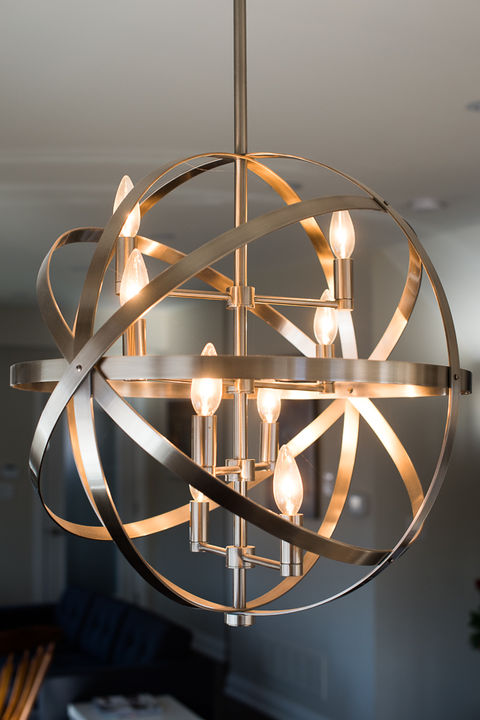 Orb-shaped chandelier with glowing lights, modern design, interior décor, Julie Reinhart Design