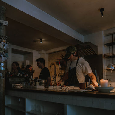 Bartender preparing drinks at dimly lit bar