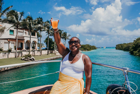 exploring tulum turquoise waters as a black woman while cruising on a yacht rented in tulum