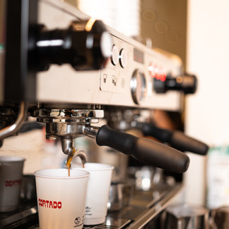 espresso shots falling in to to-go cups