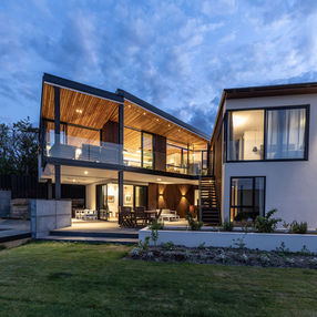 fragmented façade of architecturally designed home, timber soffit, steel structure, balcony, night lighting, based in Christchurch