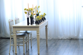 Yellow and white flowers in black vases