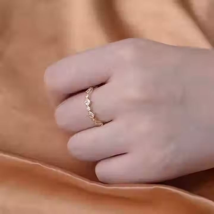 Thumbnail: Princess full eternity ring: Sterling silver, Yellow gold  vermeil with alternating round and princess-cut cubic zirconia stones, modeled on hand with satin background