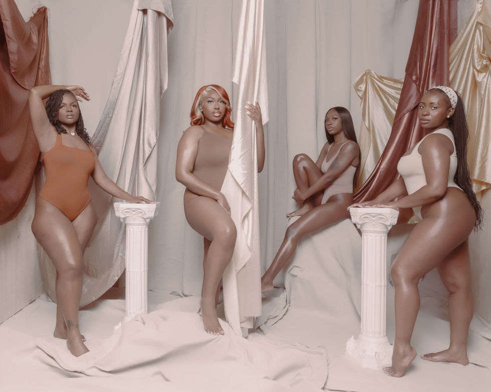 Centered model in brown bodysuit showcasing skin and confidence.