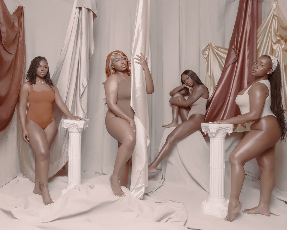 Greco-Roman themed trio portrait with draped bronze and white fabric.