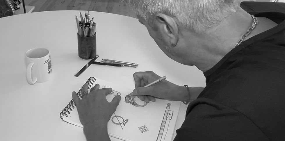 Eye-level view of a jeweler sketching a custom engagement ring design