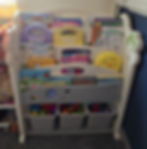 Children's bookshelf with books and toys