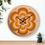 Thumbnail: Groovy retro wall clock with a swirling psychedelic flower design in warm orange and pink hues.