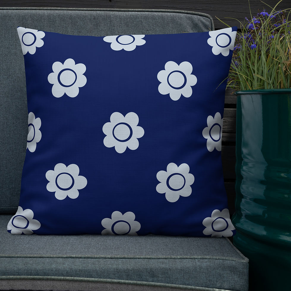 Blue cushion with light blue flower pattern on a gray outdoor sofa. Dark wooden background and green potted plant nearby. Cozy and serene setting.