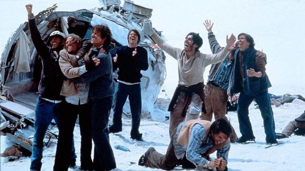 Alive: A group embraces in the snow near a wrecked fuselage, celebrating survival—hope endures even in the harshest conditions.
