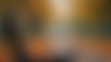 Bench in a park with autum leaves falling in the background