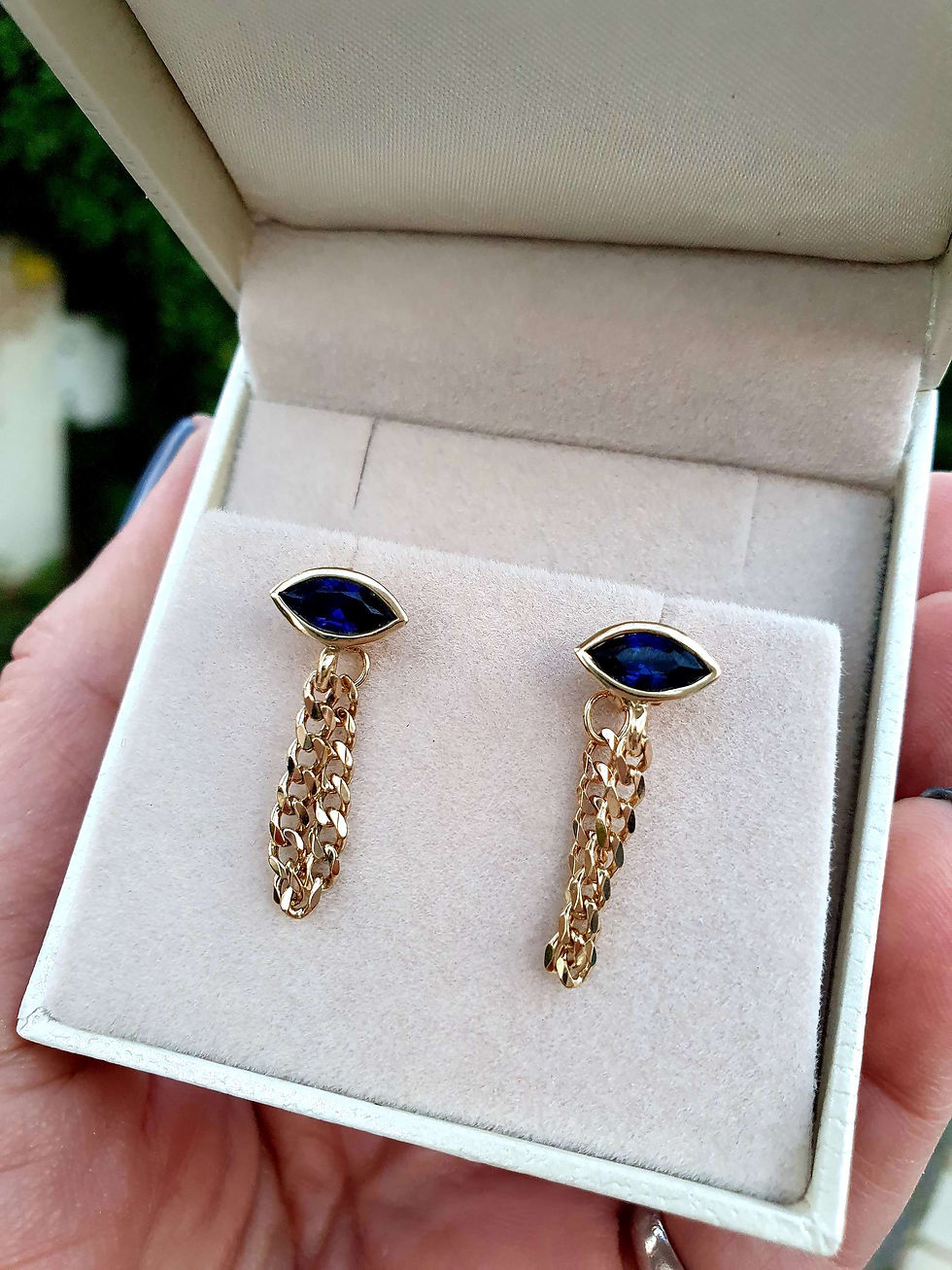 Thumbnail: 14k yellow gold eye earrings with a drop chain inlaid with lab sapphires