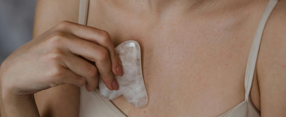 gua sha tool on female chest