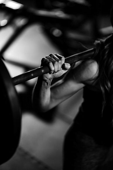 A woman lifting a barbell in a gym_edited.jpg