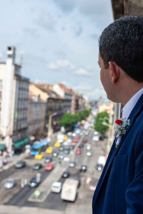 Groom looking out of his Budapest Hotel window