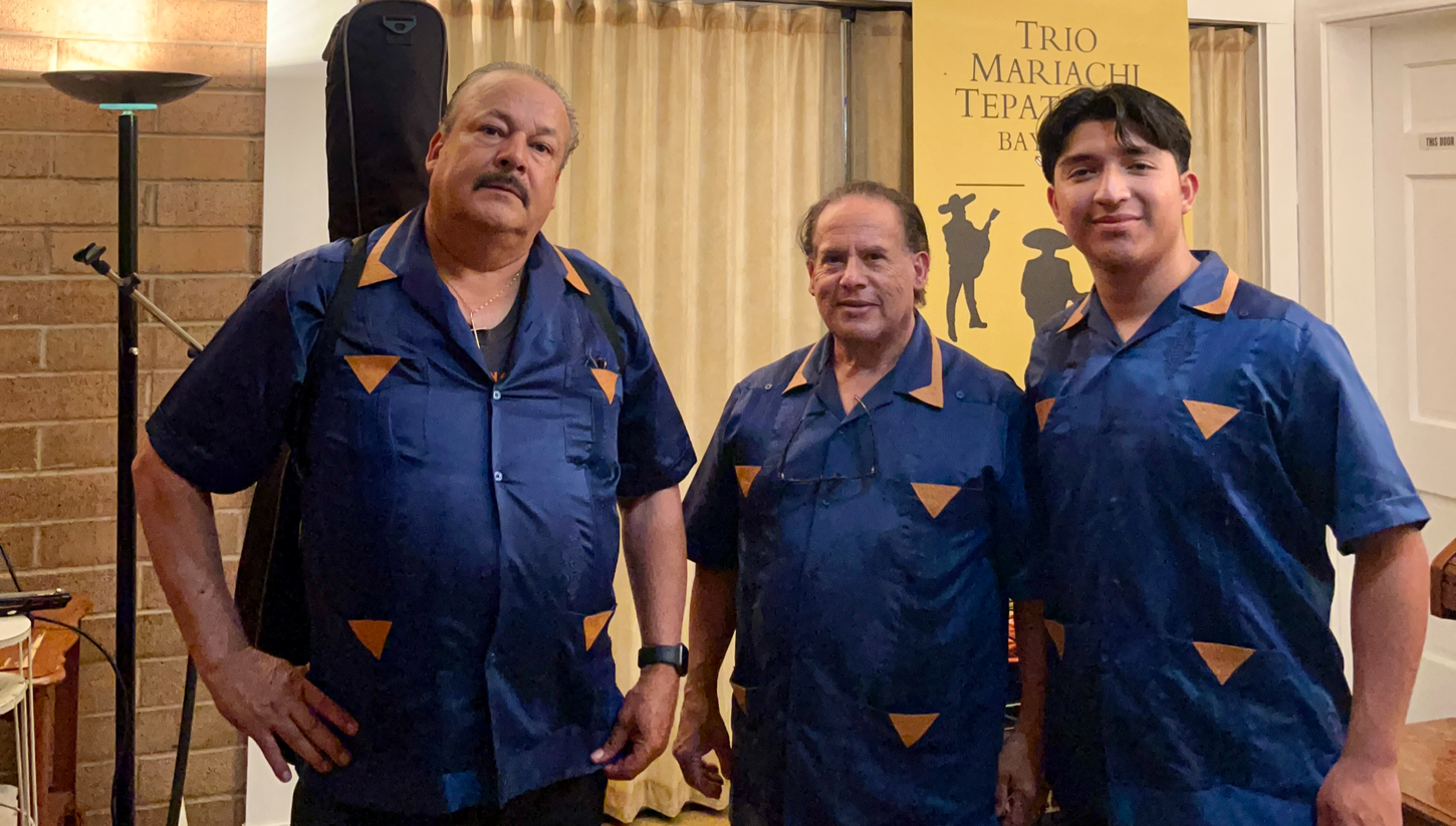 Trio Mariachi Tepatitlan performs at a funeral service in San Francisco, CA, dressed in traditional mariachi attire, playing soothing and heartfelt music to honor the deceased and comfort the grieving family and friends.