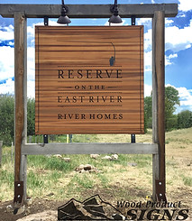 Personalized wooden hotel name sign outdoor in the side of the road that says "Reserce on the east river River homes".