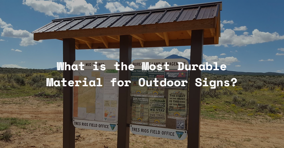 Wooden info sign with pamphlets under a clear blue sky in a grassy field. Text asks, "What is the Most Durable Material for Outdoor Signs?"