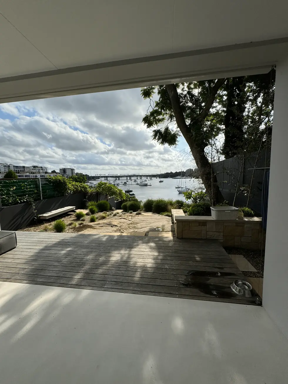 Modern patio with harbor view and wooden deck.