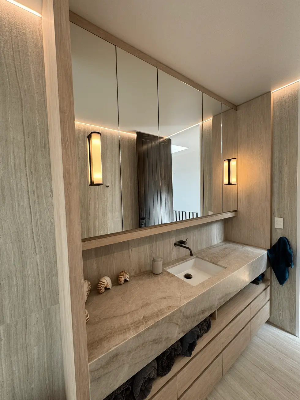 Modern bathroom with large vanity, rectangular sink, and mirror.