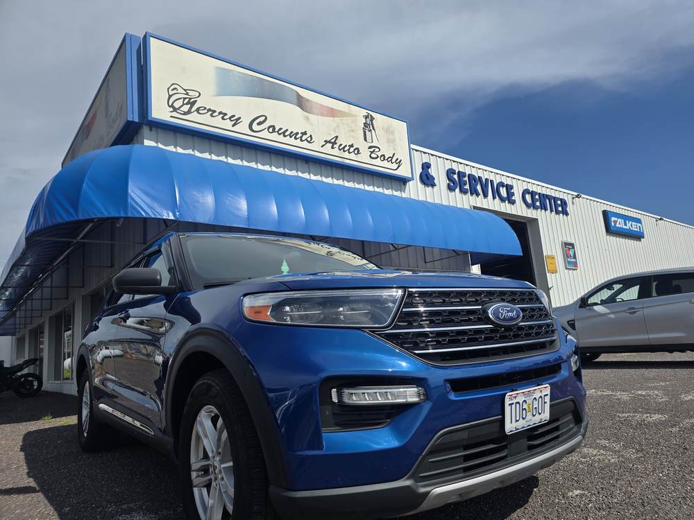 Finished blue Ford Explorer in front of Gerry Counts