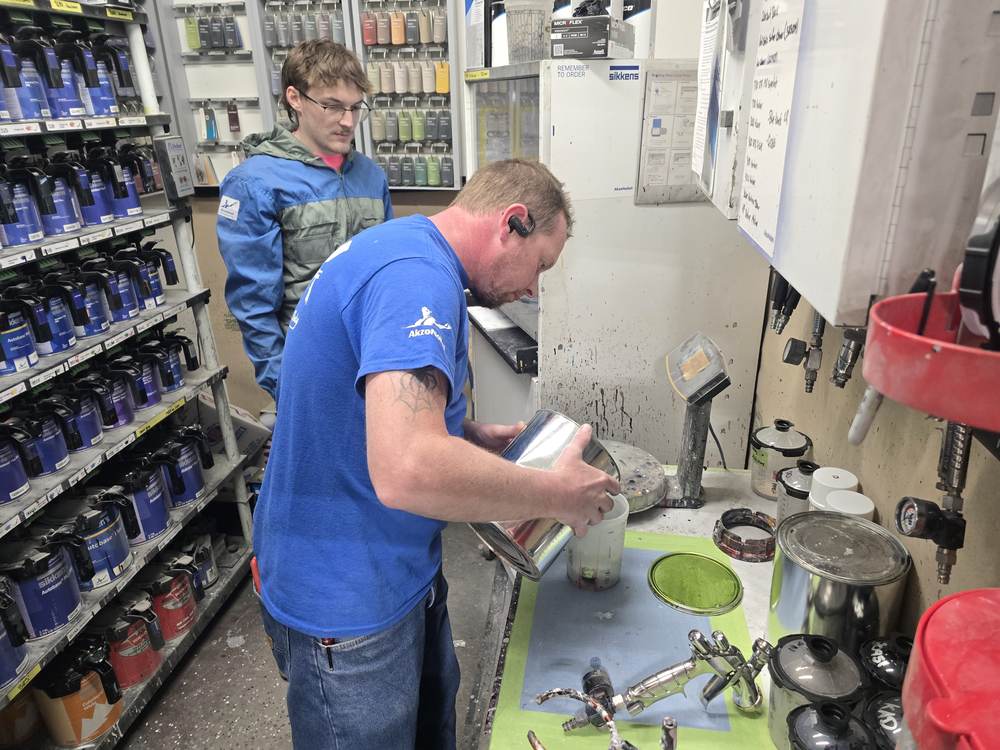 Mixing paint in the shop's color lab