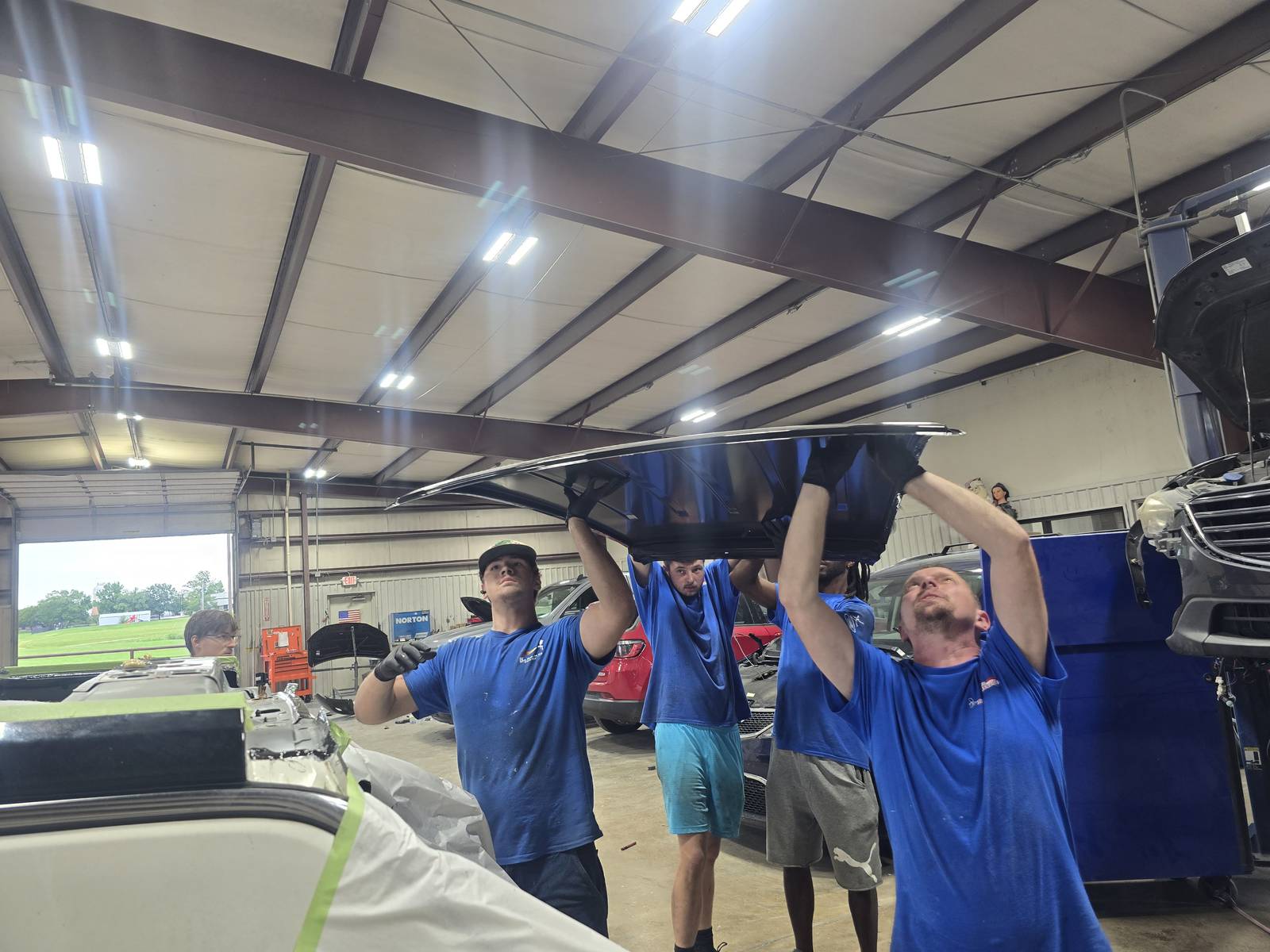 The Gerry Counts crew lifting a hood together