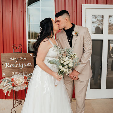 Newly married couple share a kiss after rustic wedding in Oklahoma