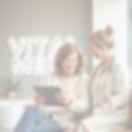 Casual, warm photo of a woman in her late 40s chatting with a female clinician at a modern