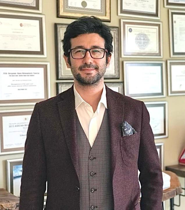 dr suleyman tas suit standing photo.jpeg