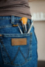 Brushes in back pocket of blue jeans