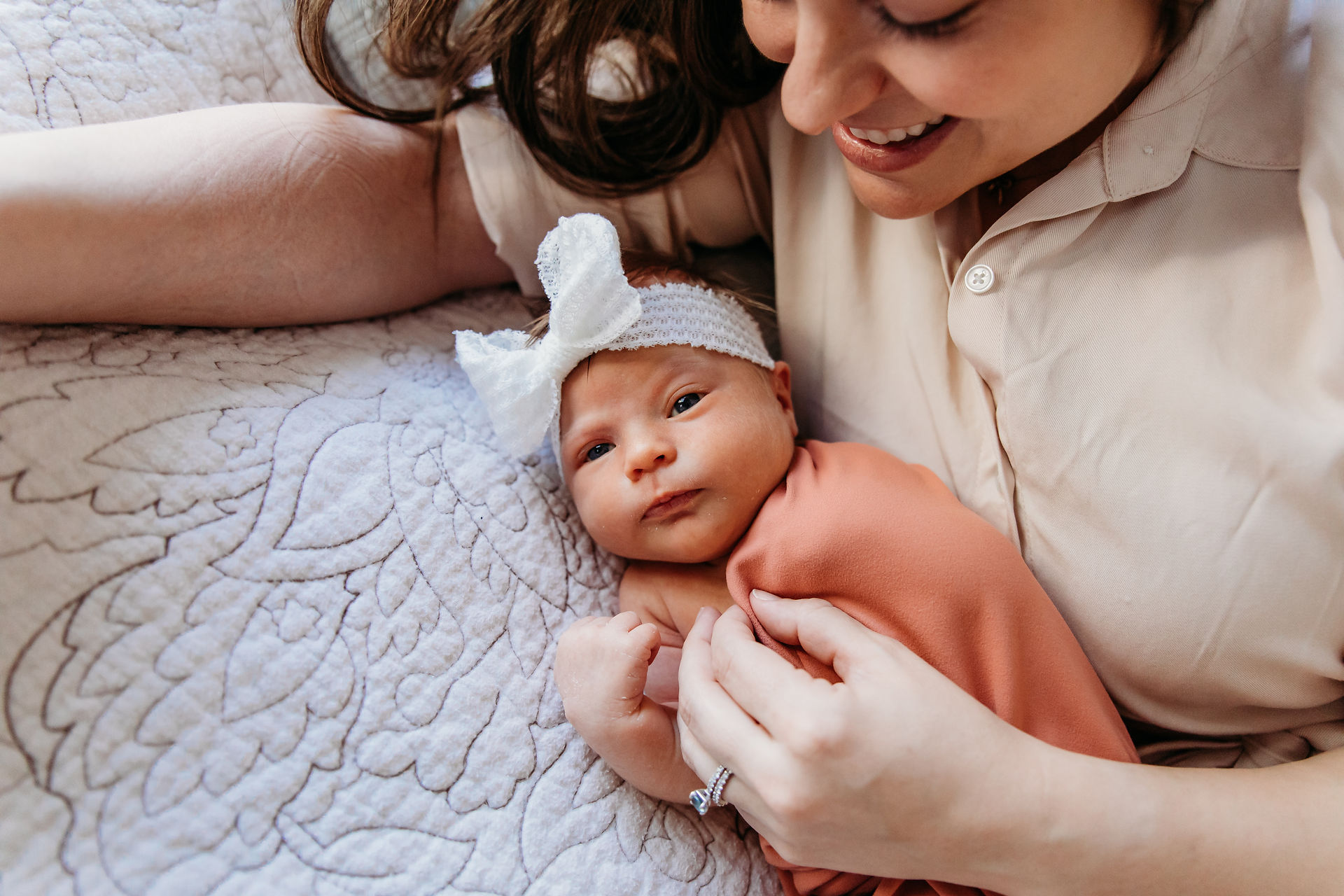 Mommy and Newborn lying on bed
