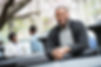 a-man-seated-at-a-table-outdoors-two-people-in-th-2023-11-27-05-30-37-utc.jpg