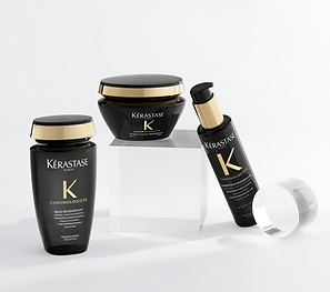 Three Kérastase Chronologiste haircare products displayed on white blocks with a clean background.