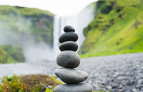 Round stones are stacked to represent balance and alignment.