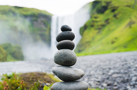 Round stones are stacked to represent balance and alignment.
