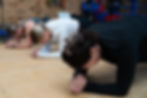 women competing a plank while working out in the gym