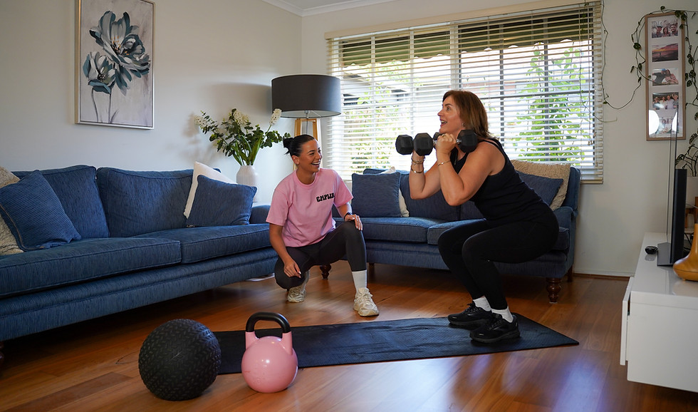 Mobile personal trainer guiding a woman through a personalised workout at home in Carnegie